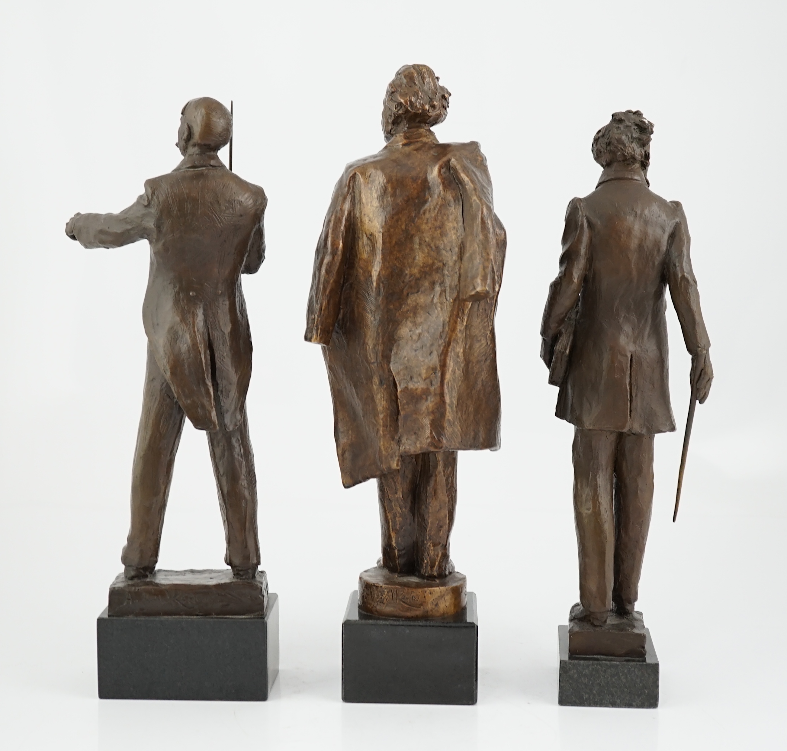 Anthony Hawken FRSS (British, b.1948), three bronze figures of composers, Gustav Mahler, Sir Edward Elgar and Mendelssohn, one standing holding a baton aloft, one standing carrying a baton and volume, the third with coat